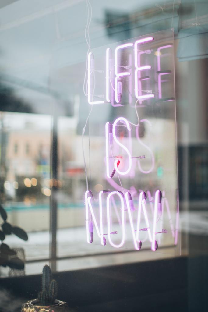 Neon with a message "Life is now"
